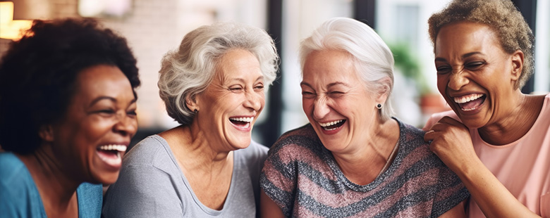 three older ladies smiling and laughing together